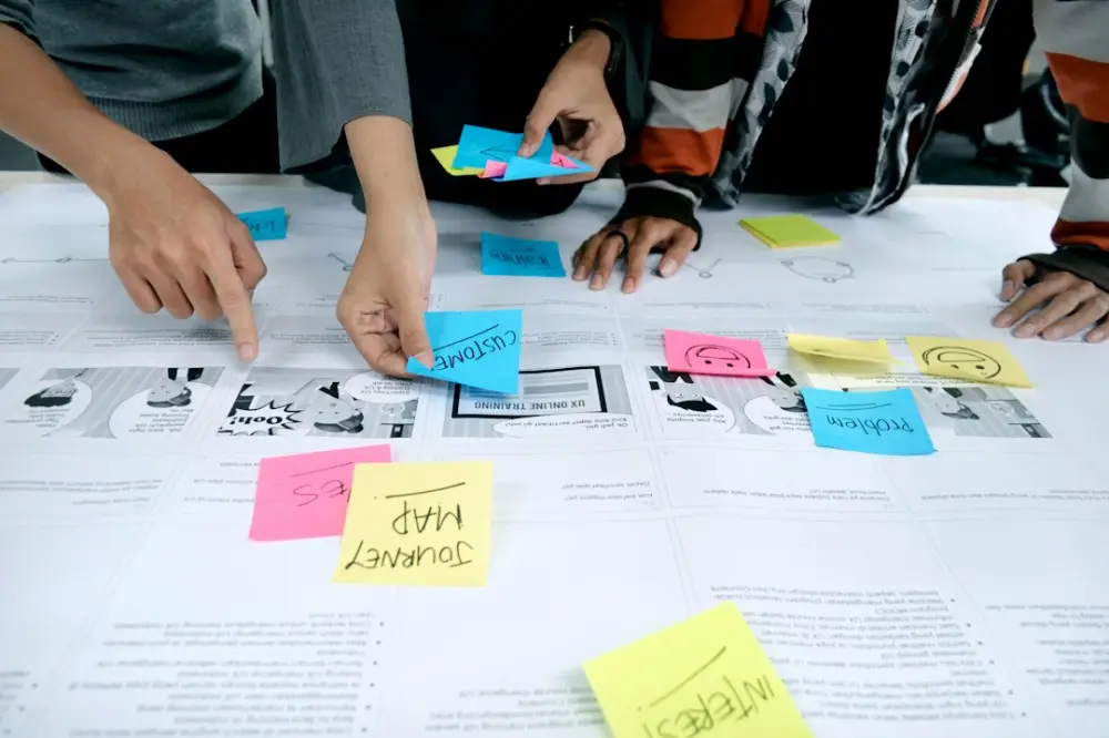 Team collaborating with sticky notes, illustrating collaborating across design and development